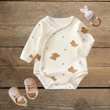 Moon & Bear cotton wrap baby romper on wood background