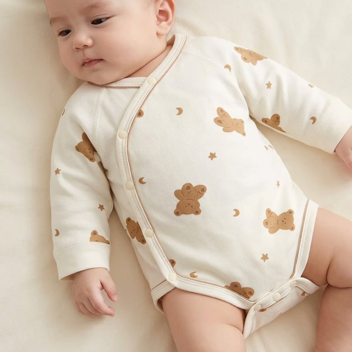 Close-up of baby wearing Moon & Bear cotton wrap baby romper