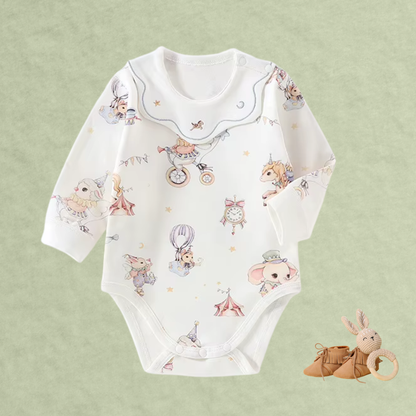 Woodland Story cotton baby romper with circus animal print on soft green background