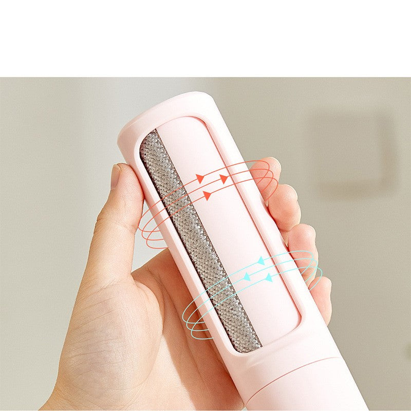 Close-up of a reusable pet hair remover roller held in one hand.
