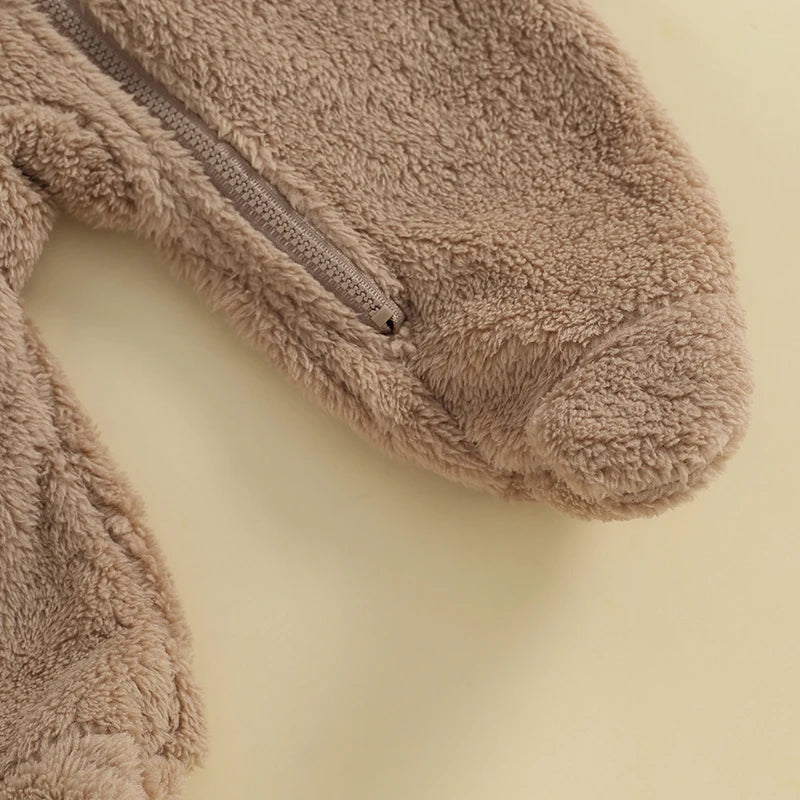 Close-up of footed design on brown fuzzy baby romper