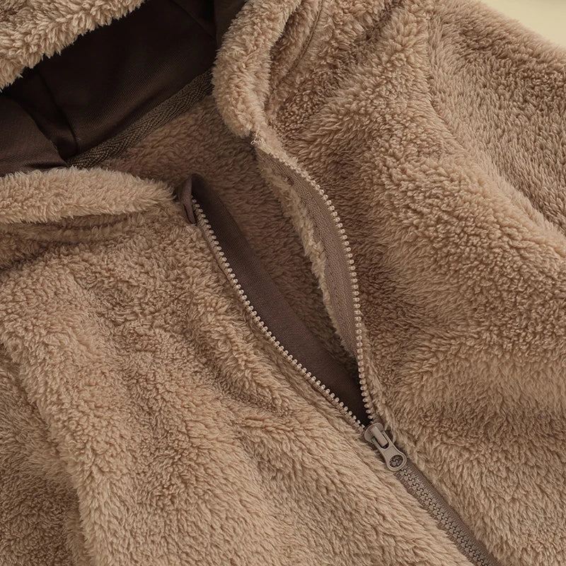 Close-up of zipper on brown fuzzy bear hooded baby romper