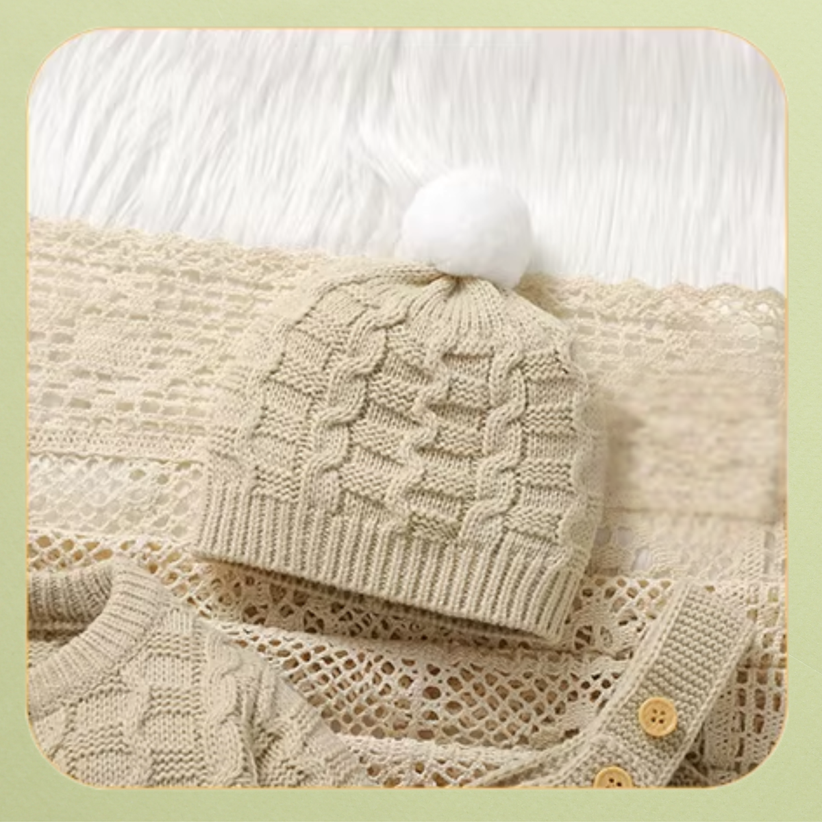 Cream cable knit baby pom-pom hat with ribbed trim