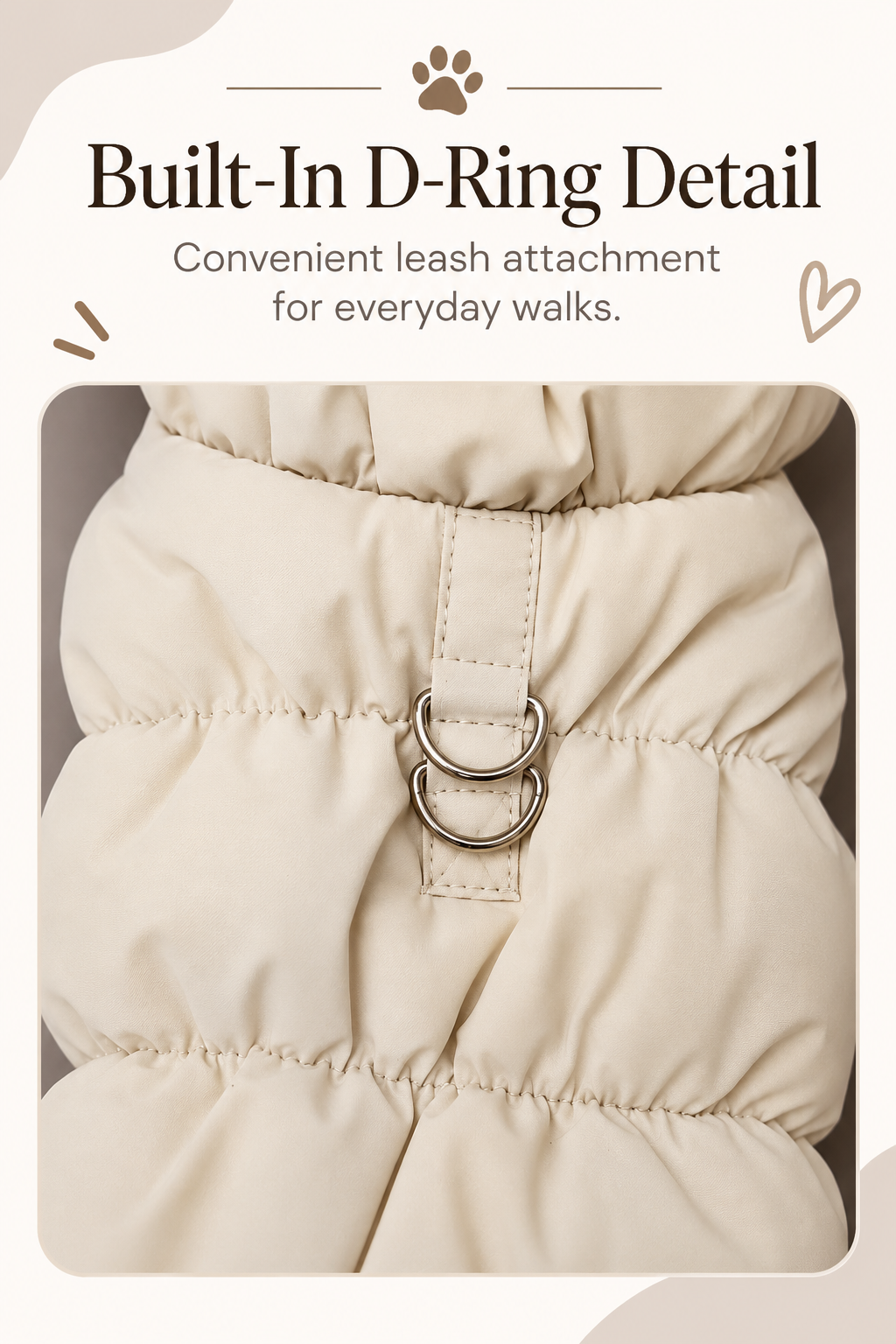 Khaki puffer pet jacket close-up showing built-in D-ring attachment