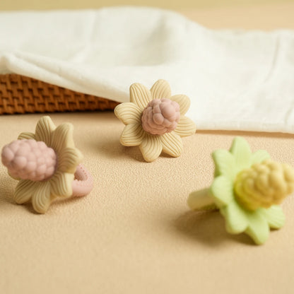 Floral LuxeBloom silicone baby teethers in Beige Bloom and Sage Bloom