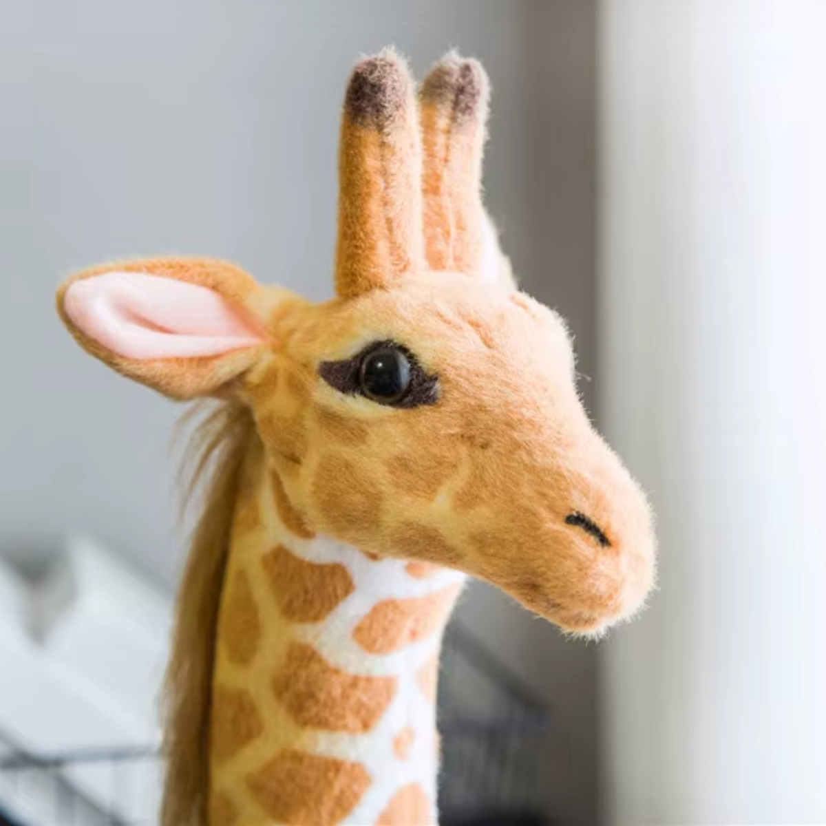 Side close-up of Giant Standing Giraffe Plush – Safari-Inspired Statement Decor showing its facial details