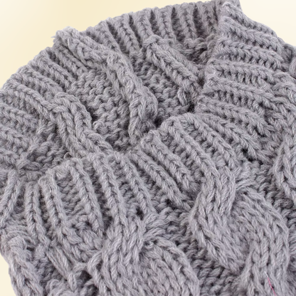 Close-up of gray cable knit dog sweater texture and stitching