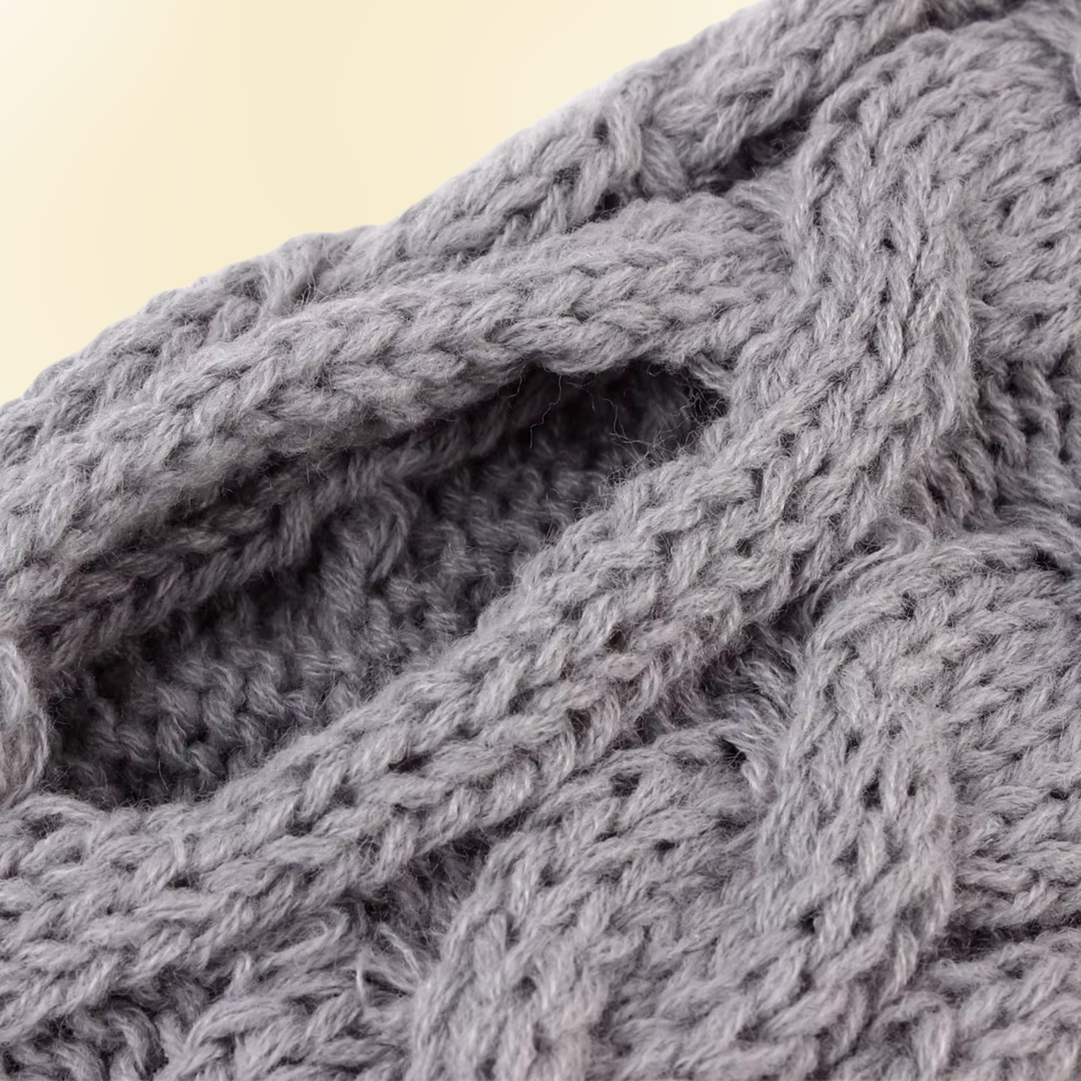 Close-up of gray cable knit dog sweater texture and stitching