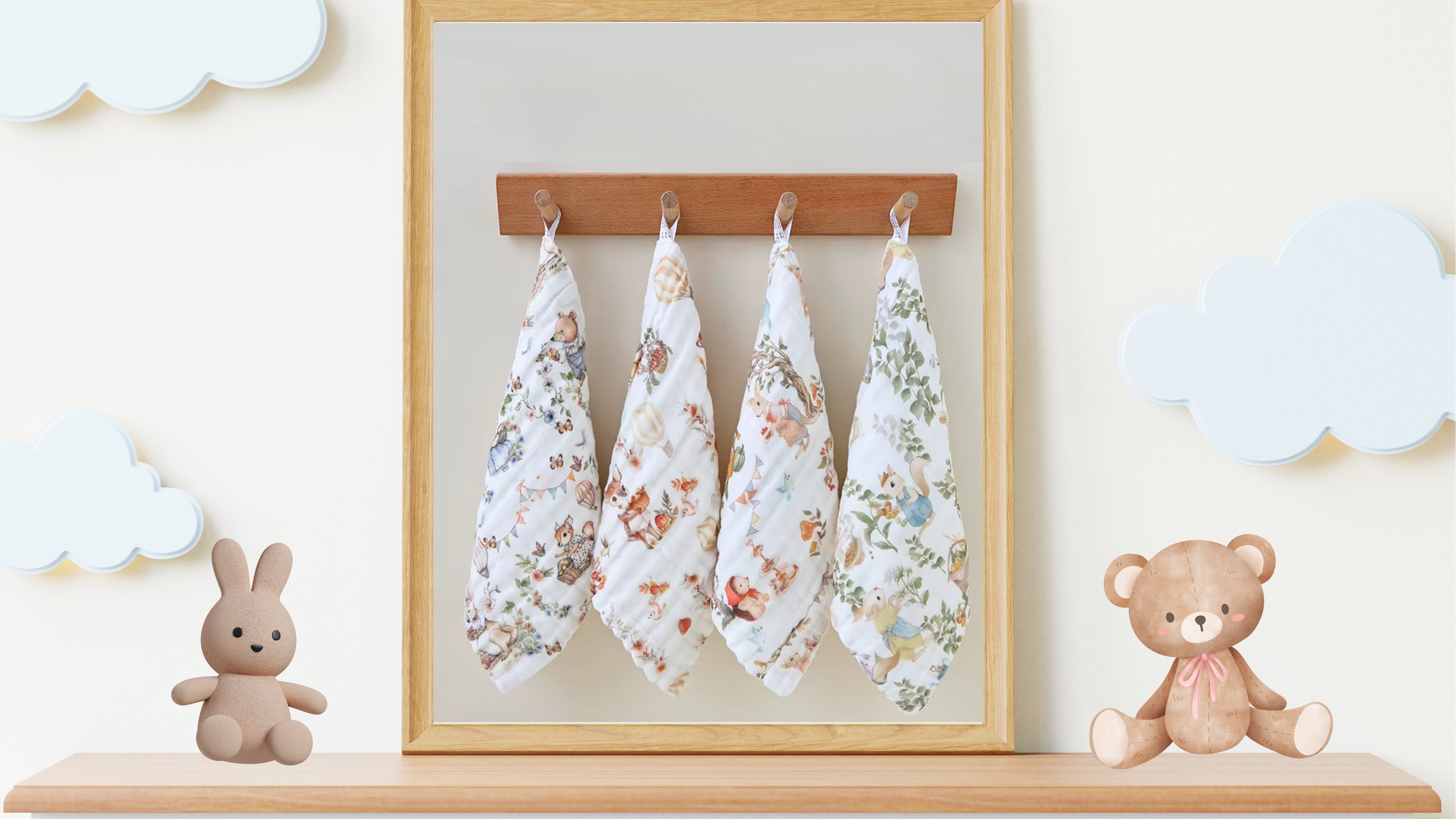“Luxury muslin baby burp cloths in whimsical woodland prints, displayed hanging on hooks with plush bunny and teddy bear nursery decor – soft 6-layer cotton gauze gift set for newborns.”