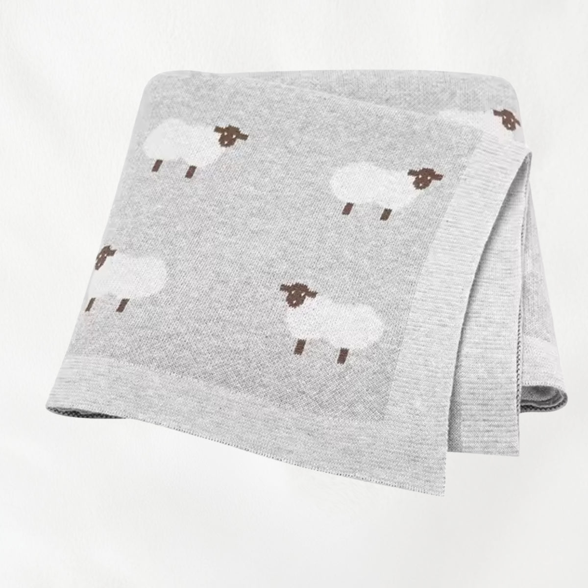 Light gray sheep knit baby blanket folded for product display