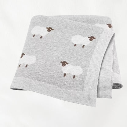 Light gray sheep knit baby blanket folded for product display