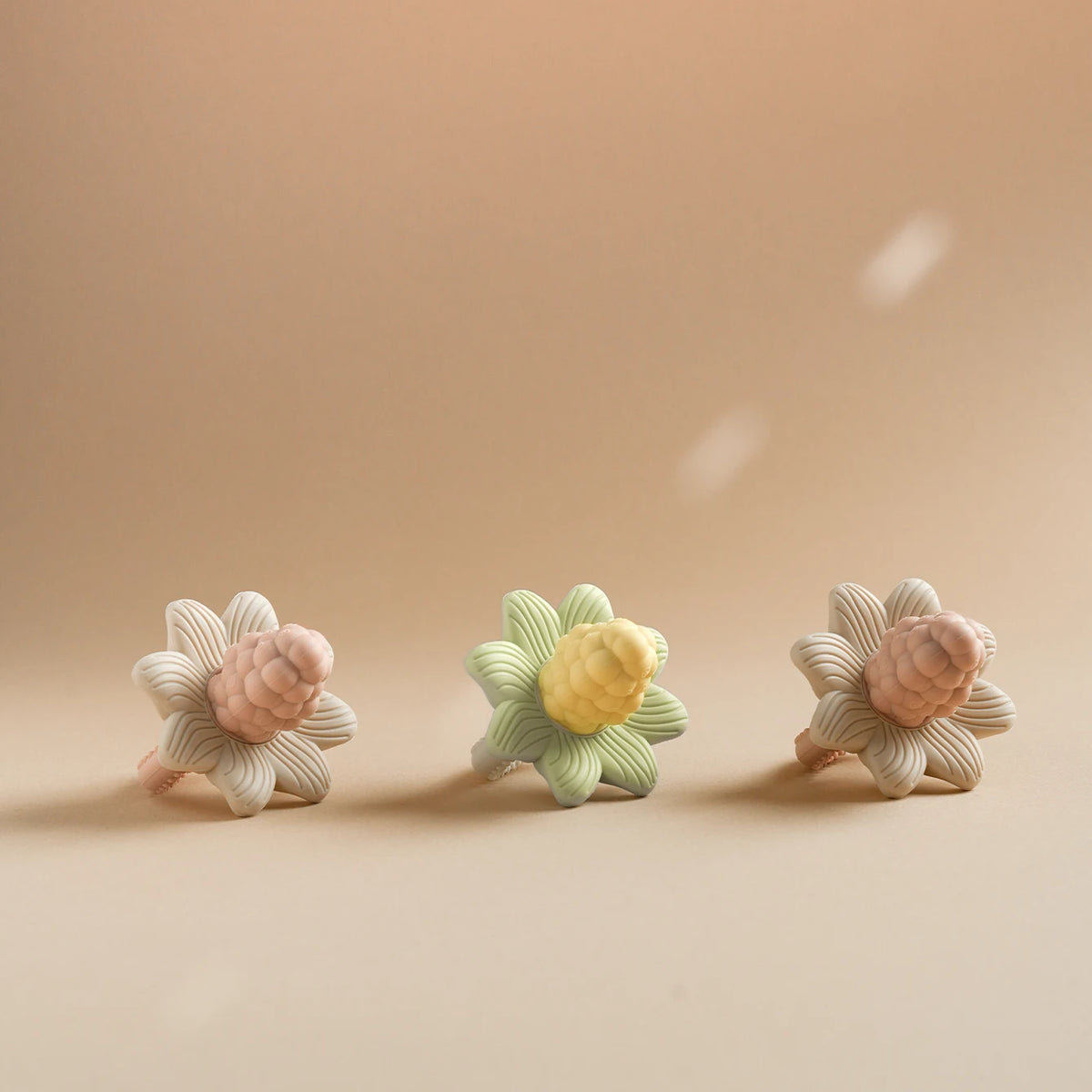 LuxeBloom silicone baby teethers in Beige Bloom, Sage Bloom and Lilac Bloom