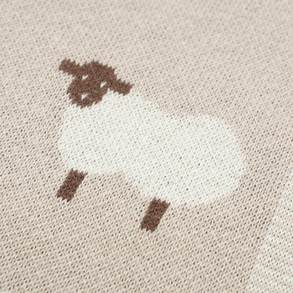 Close-up of sheep pattern on knit baby blanket