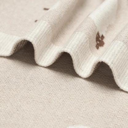 Close-up of soft knit texture and finished blanket edge