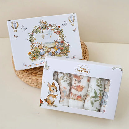 “Luxury muslin baby burp cloths gift set in illustrated woodland packaging, featuring whimsical animal prints in a keepsake box – perfect for baby showers and newborn gifting.”