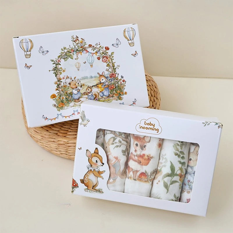 “Luxury muslin baby burp cloths gift set in illustrated woodland packaging, featuring whimsical animal prints in a keepsake box – perfect for baby showers and newborn gifting.”