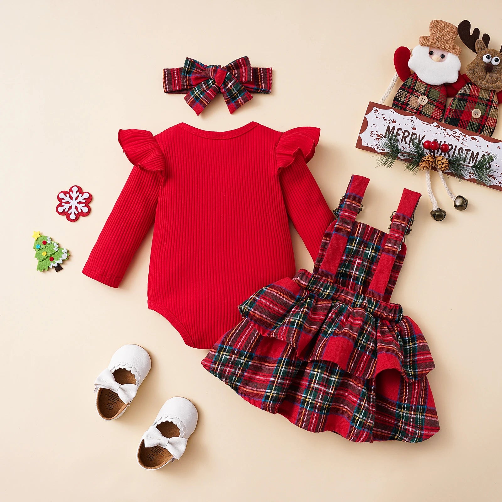 Back view of baby girl plaid Christmas romper and dress set with bow straps and red ruffle top.