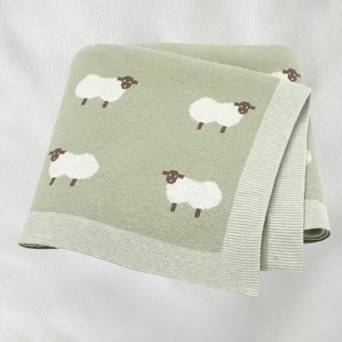 Sage green sheep knit baby blanket folded for product display