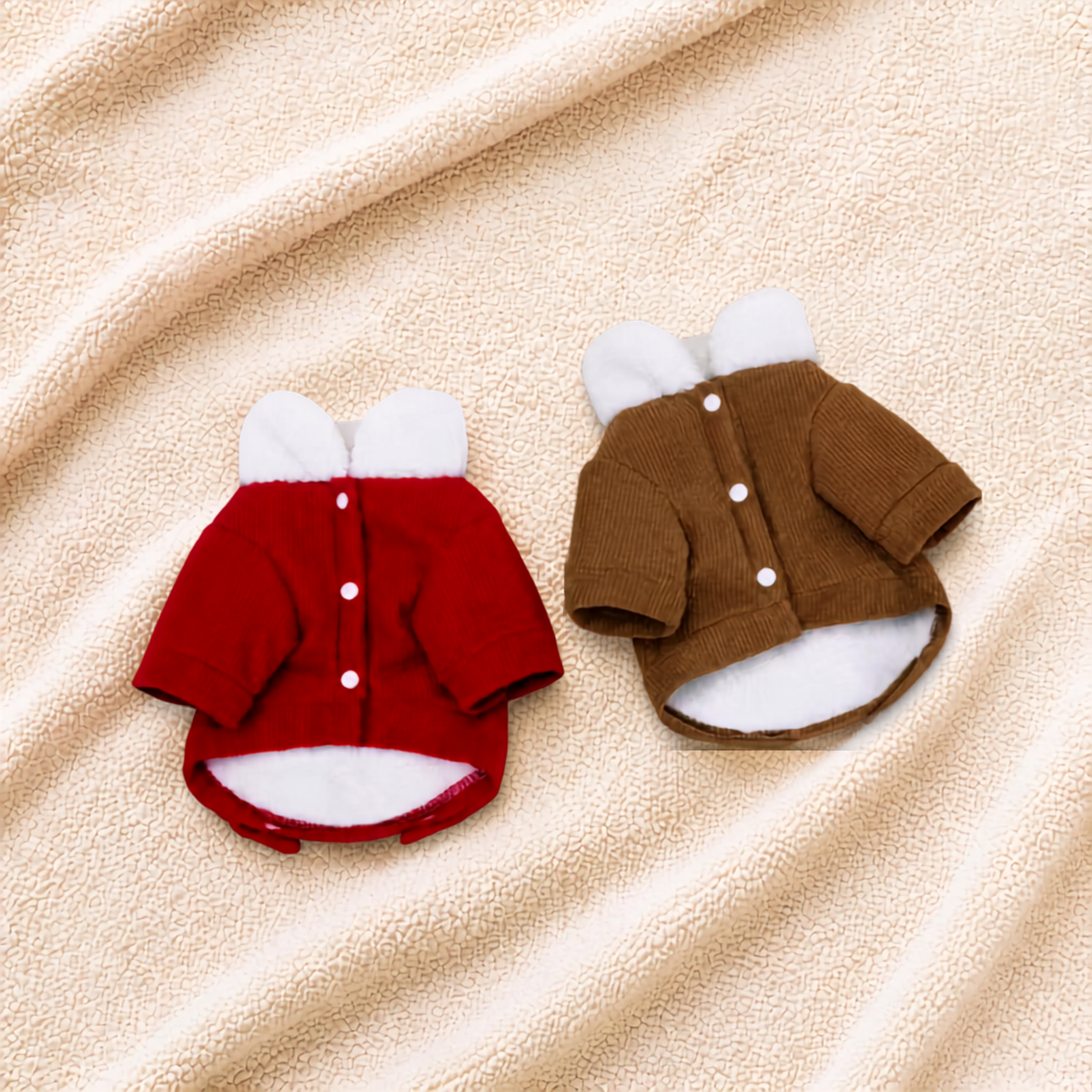 Back view of red and coffee corduroy pet coats showing snap-button closures and fleece lining