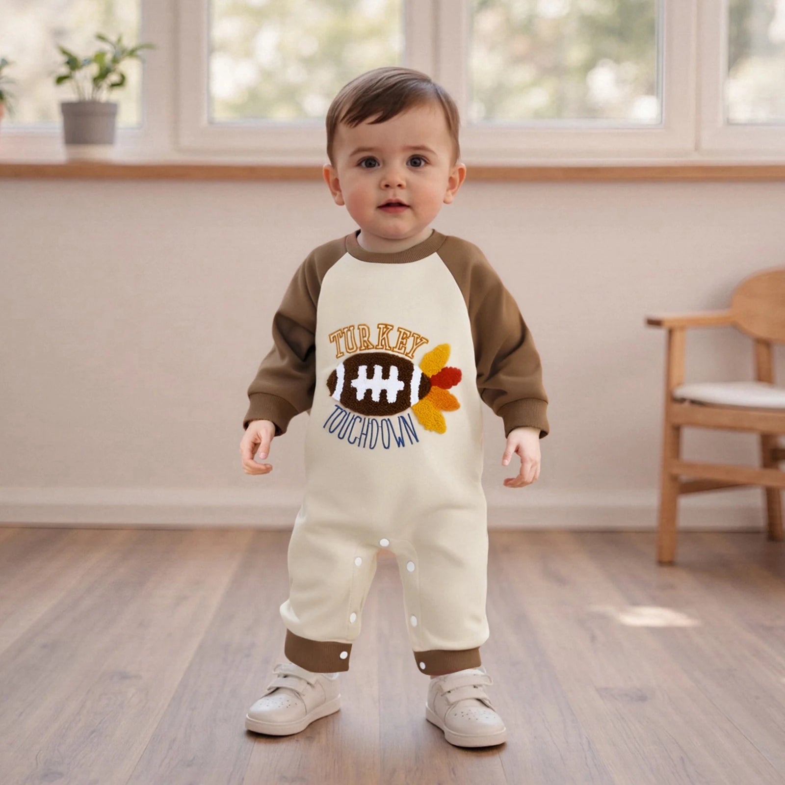 "Baby boy wearing Turkey Touchdown romper with turkey and football design, cozy Thanksgiving outfit"