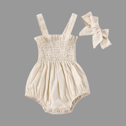 Soft Apricot smocked baby girl romper with matching bow headband