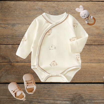 Tiny Bear cotton wrap baby romper on wood background