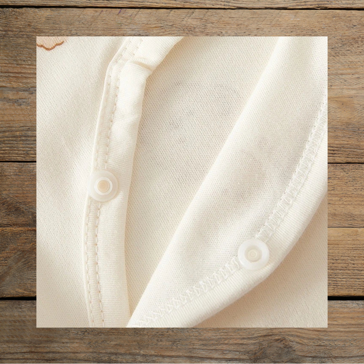 Close-up of cotton fabric and snap closure on Tiny Bear baby romper