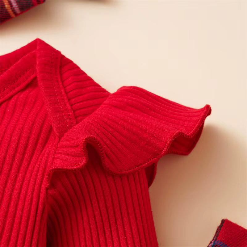 Lace-trimmed plaid Christmas baby dress detail showing fine stitching.