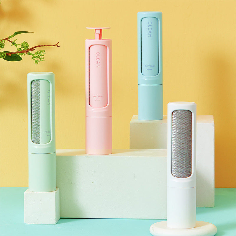 Reusable pet hair remover rollers in white, pink, blue, and green.